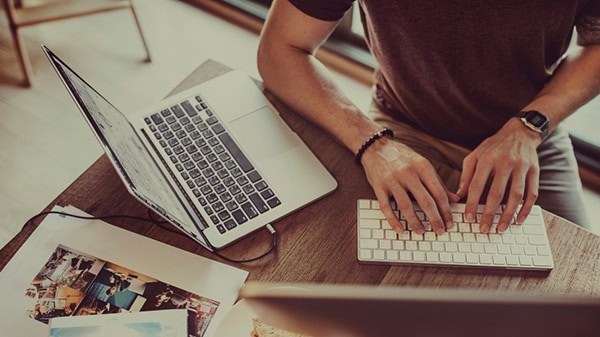 Blogs and newsletters - Person typing on their laptop